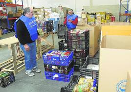 Dos voluntarios descargan alimentos en la sede del Banco de Alimentos de la capital