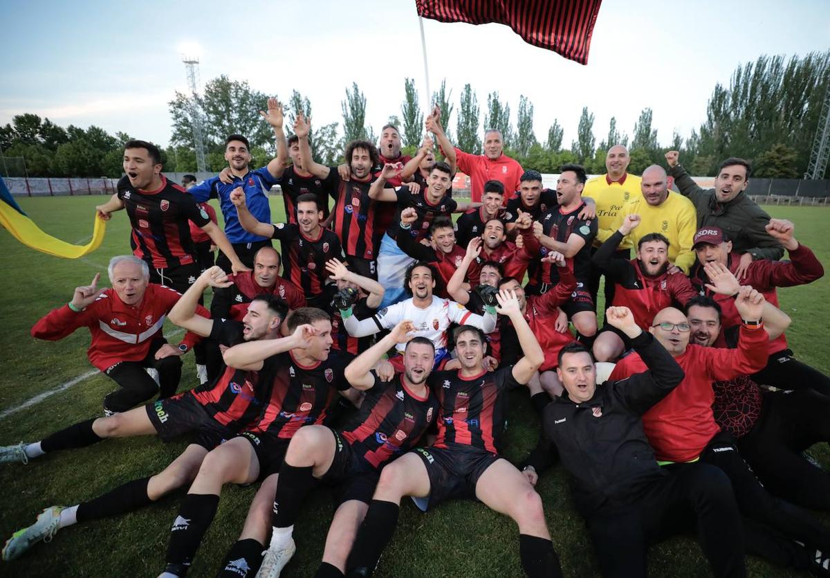 Plantilla, cuerpo técnico y directivos del Laguna celebran el ascenso sobre el césped.