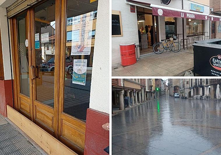 Tablón para proteger el local del agua, junto con un bar que abrió este lunes con normalidad y la lluvia del día después de la tromba de agua.