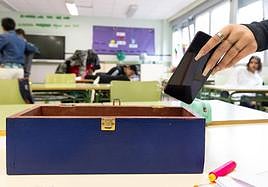 Alumnos del instituto Galileo dejan su móvil en una caja al entrar al aula.