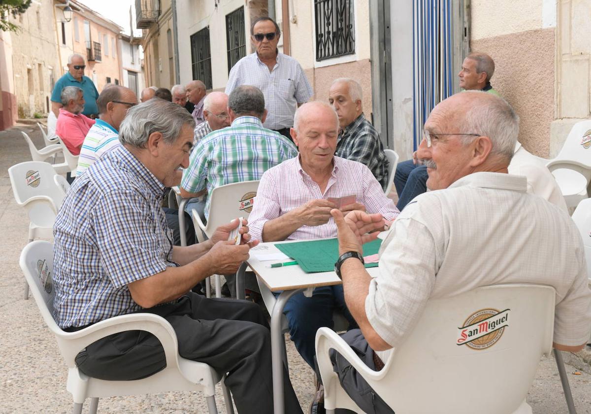 Varios vecinos juegan en una terraza a las cartas en Tiedra (Valladolid).