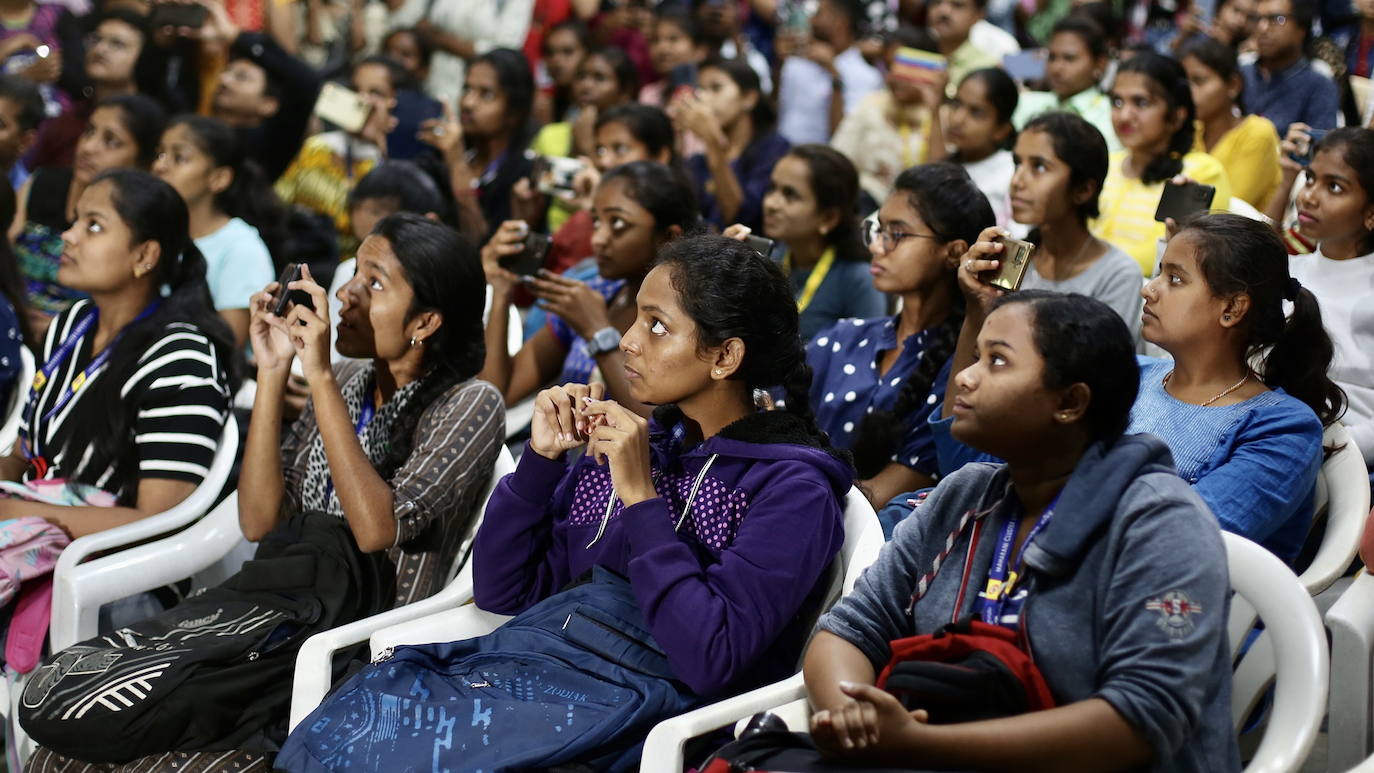 Estudiantes de la India observan con atención el despegue del cohete.