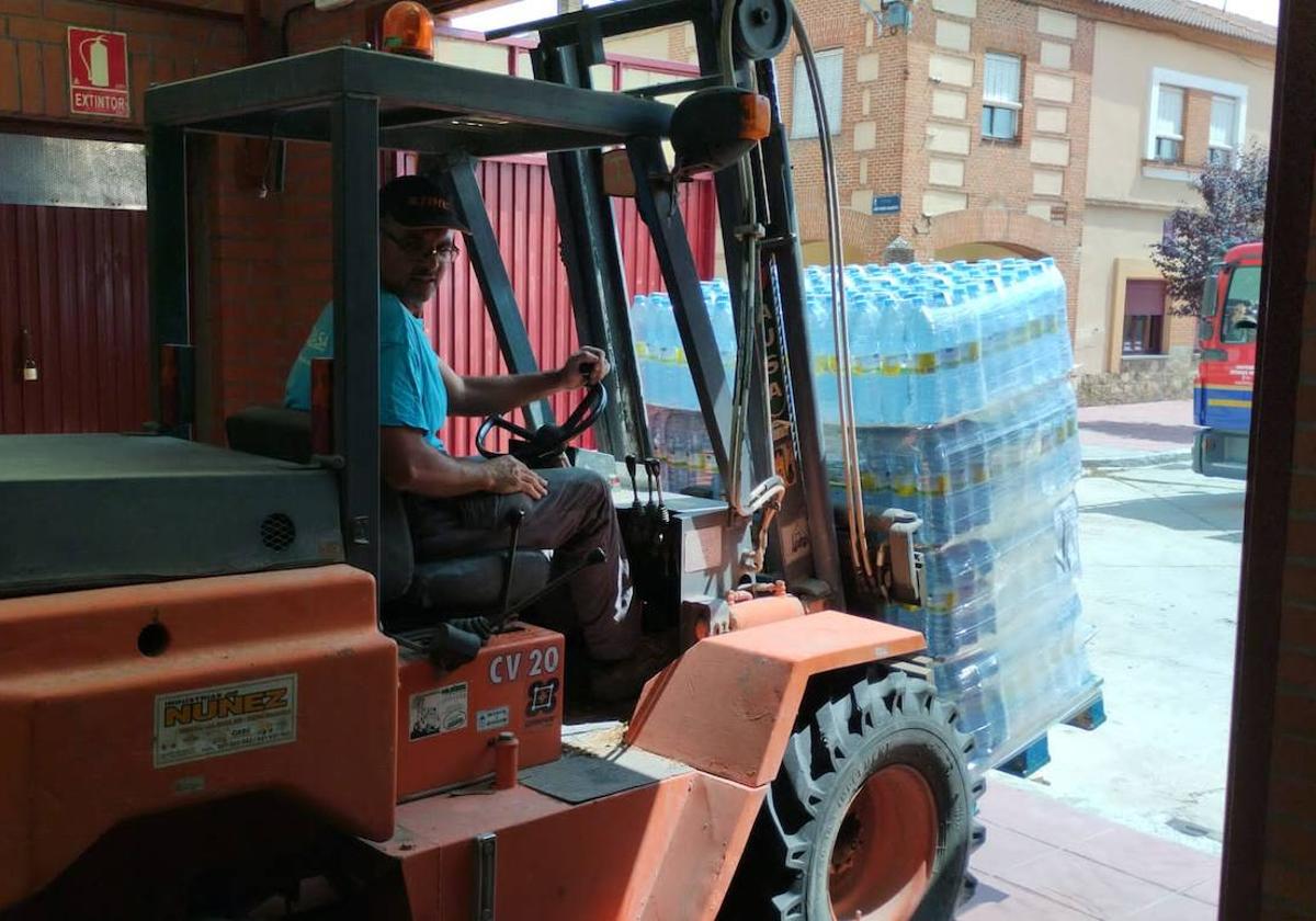 Un hombre utiliza maquinaria para el reparto de agua en Navas de Oro.