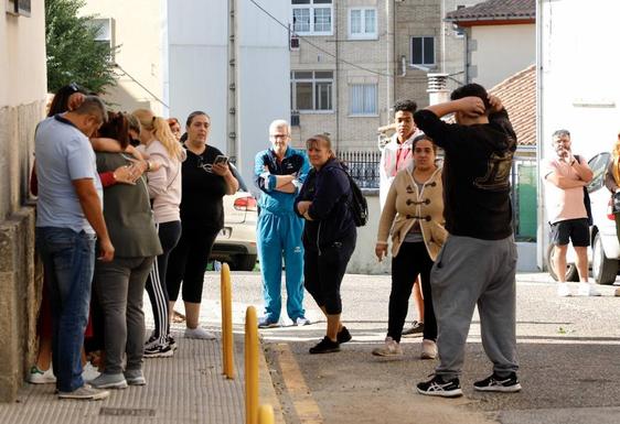 Familiares, vecinos y amigos de la mujer asesinada en Béjar, en las inmediaciones de la vivienda de la víctima.