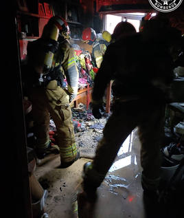 Bomberos en el interior de la vivienda siniestrada.