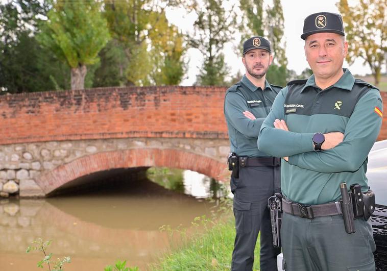 José Antonio González, delante, y David Ramiro, detrás, en la zona en la que sacaron a la mujer de las aguas.