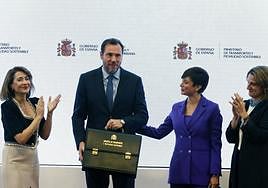 El nuevo ministro de Transportes, Óscar Puente, tras recibir la cartera de mano de la ministra saliente, Raquel Sánchez (i).