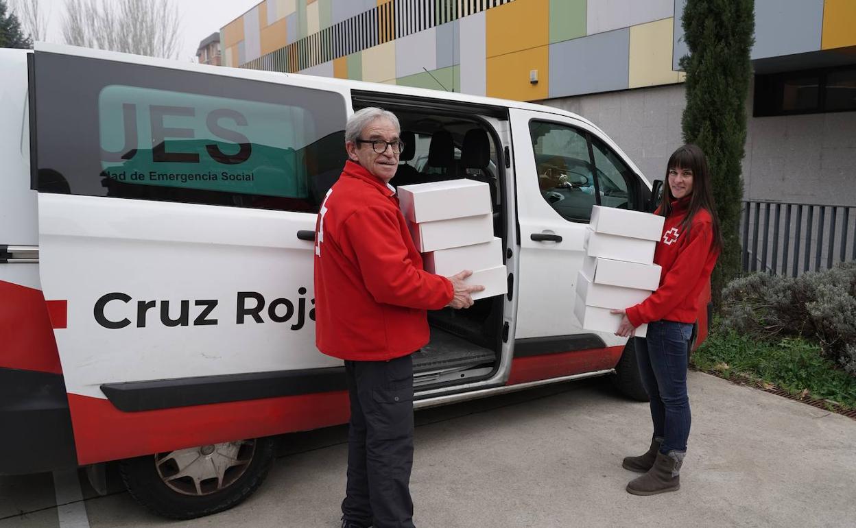 Miembros de Cruz Roja recogen los roscones de la Escuela de Cocina. 