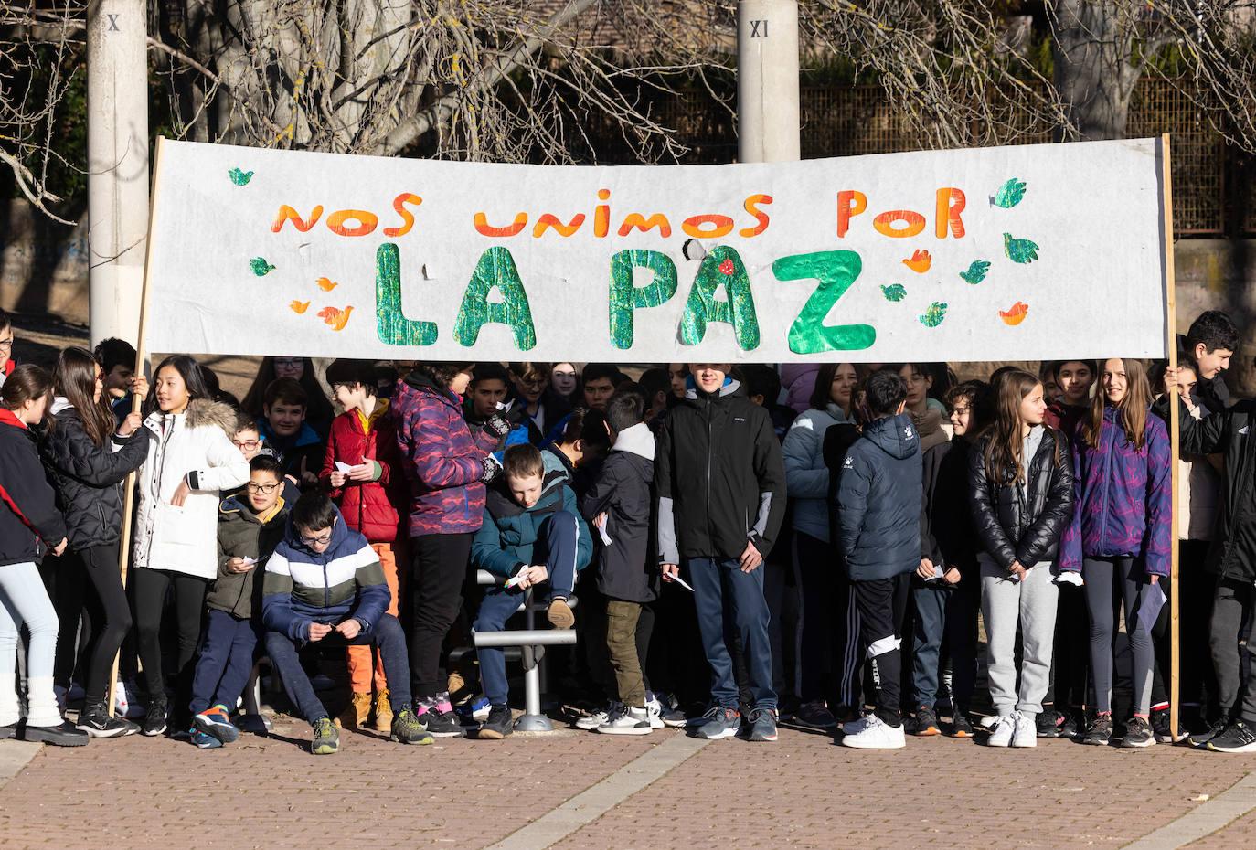 Varios niños y niñas del IES Parquesol sostienen pancartas para conmemorar el Día Mundial de la Paz.