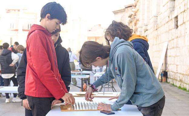 Unos chavales practican con juegos de lógica matemática en la Plaza de Portugalete 