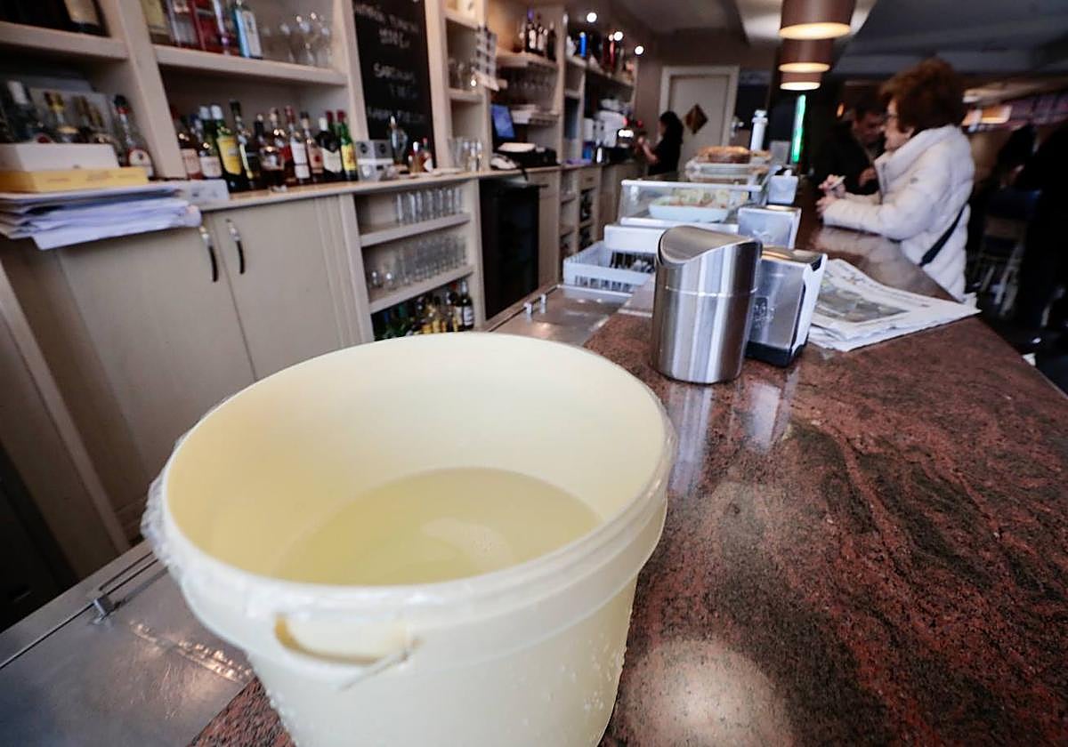 Un cubo de agua en la barra del Bar lladolid de la avenida de Medina del Campo, durante el corte del suministro en Arturo Eyries.