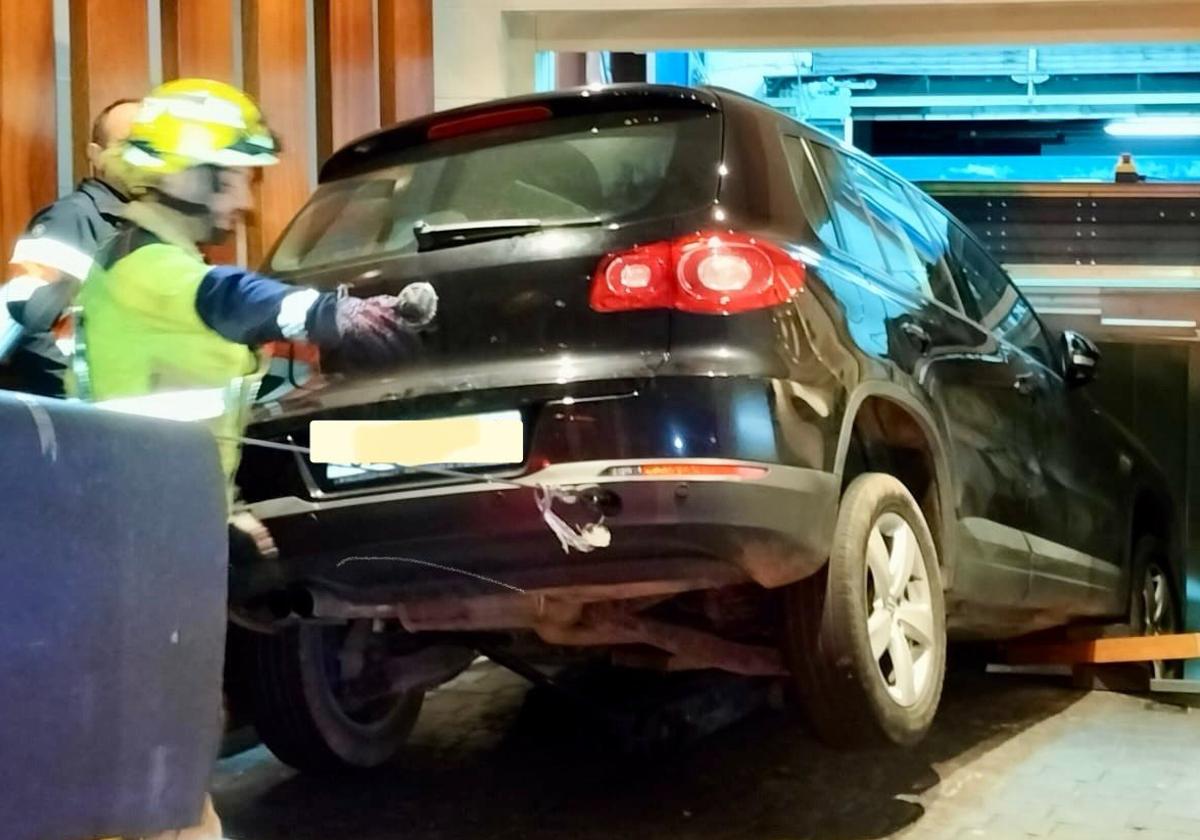 Una grúa y los Bomberos de Valladolid sacan el coche dañado.