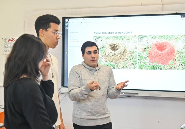 Los tres alumnos seleccionados por Huawei presentando su proyecto