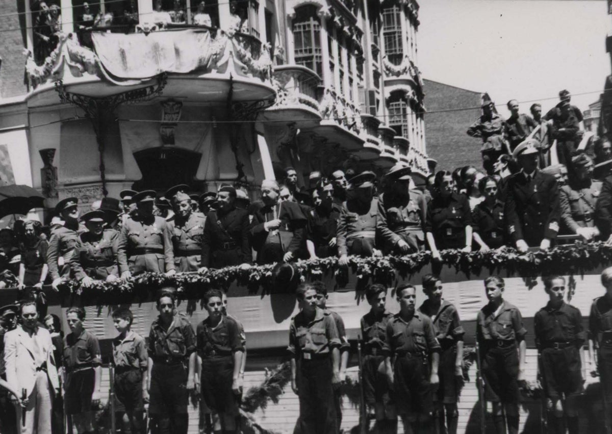 Imagen secundaria 1 - Arriba, detalle de la tribuna instalada en el Campo de San Isidro. Abajo, tribuna de autoridades en la calle de Colmenares y decoración de la fachada del Ayuntamiento.