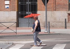 Una mujer se protege del sol en la plaza de España.