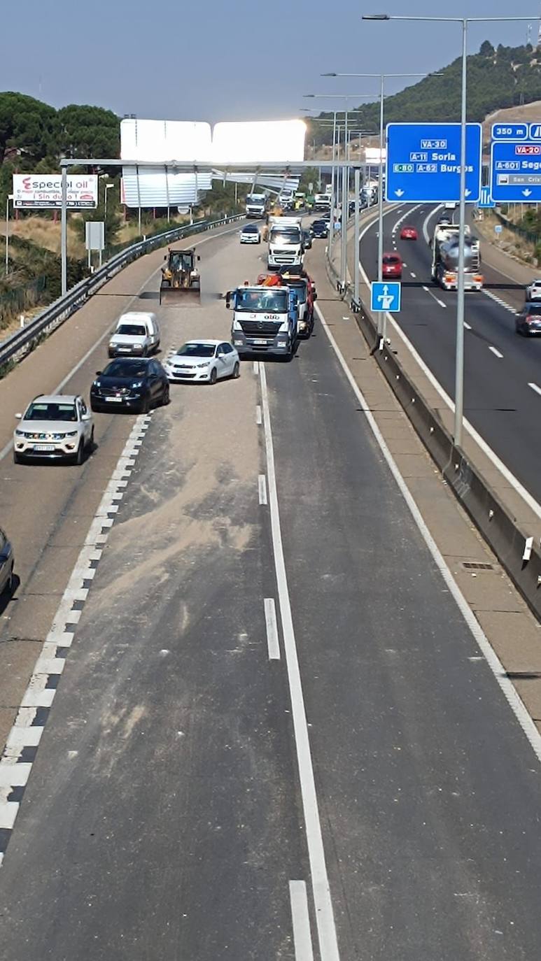 La señal permanece destrozada por el camión mientras se trata de limpiar la grava derramada.