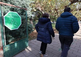 Dos personas entran en el colegio Pradera de la Aguilera de Villamuriel, con el sello de espacio de humo.