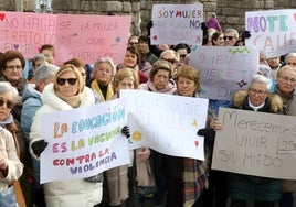 Mujeres que tomaron parte en la marcha muestran carteles contra la violencia machista.