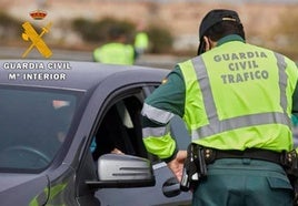 Un agente de la Guardia Civil intercepta un vehículo en un control.