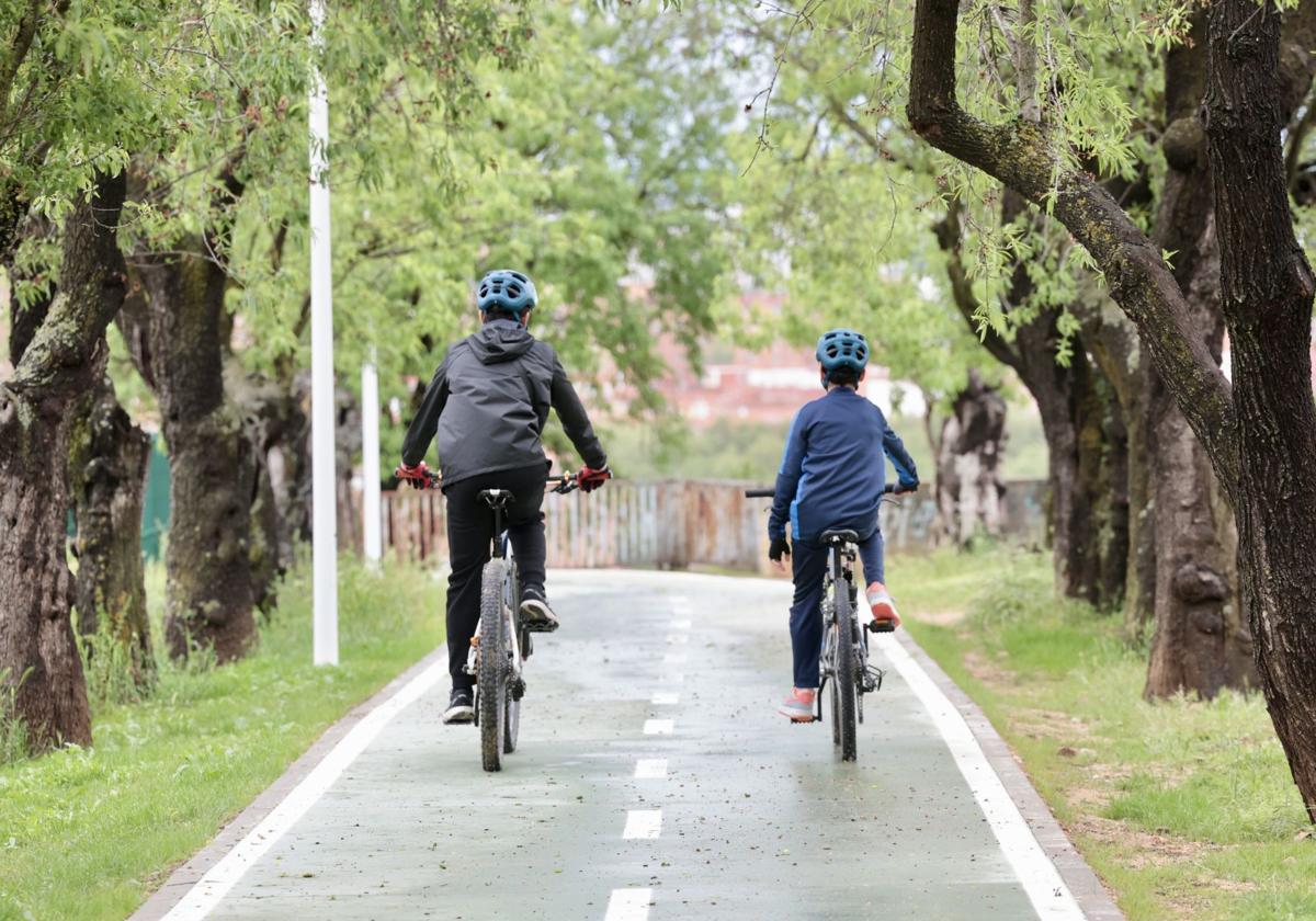 Dos ciclistas circulan por el carril bici de Parquesol.