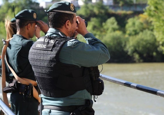 Varios agentes de la Guardia Civil otean el río para intentar encontrar al desaparecido.