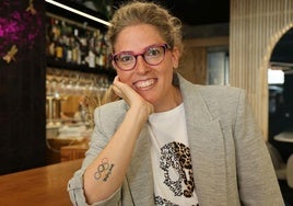 La olímpica vallisoletana Laura López posa en la barra del restaurante Pico Fino y luce su tatuaje que conmemora la medalla de plata que ganó en los Juegos de Pekín de 2008.