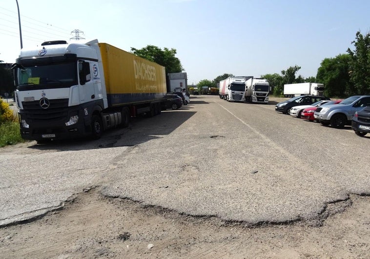 Restos del asfalto de la antigua calzada en la explanada sin urbanizar de la calle Topacio utilizada como aparcamiento.