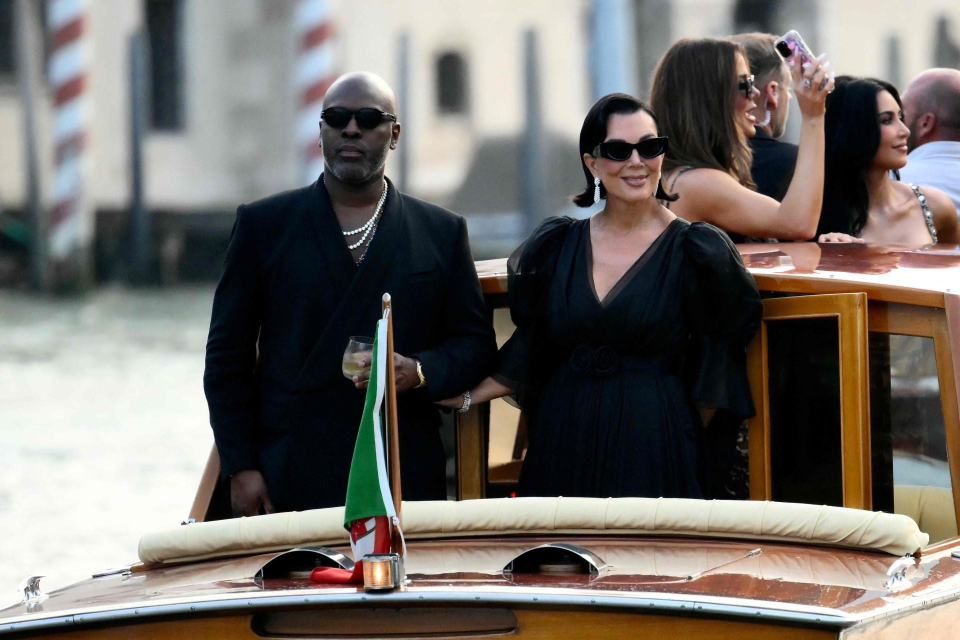 Corey Gamble junto a Kris Jenner, con dos de las hermanas Kardashian detrás de ellos.