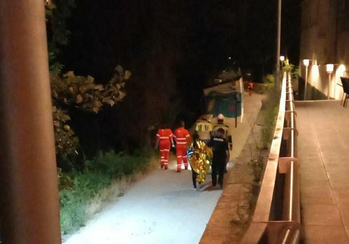 Los bomberos, junto al joven tras sacarlo de río.