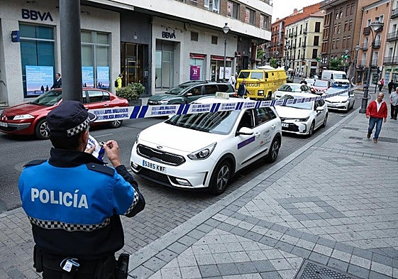 Un policía acordonada la parada de taxis de Angustias, por las que discurrirá la prueba ciclista este jueves.