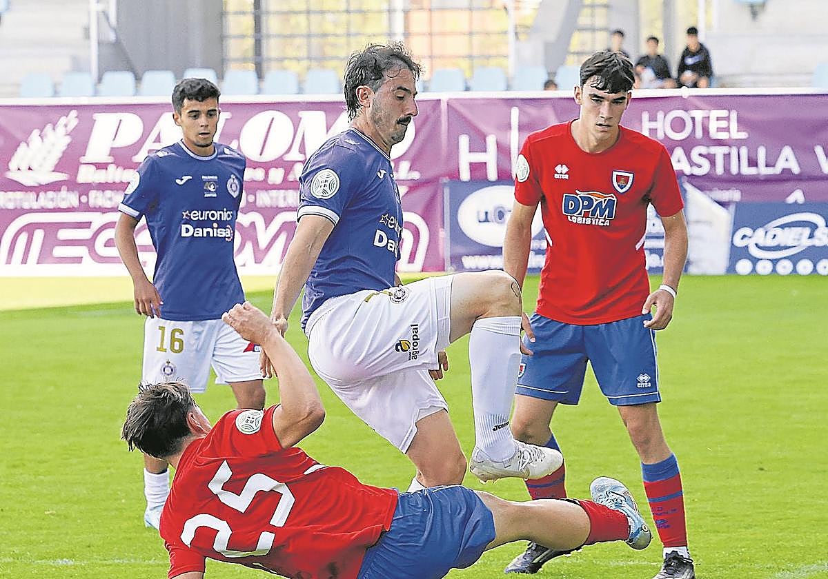 Felipe Peredo, autor ayer de uno de los goles del Palencia Cristo, salva la entrada de un rival.