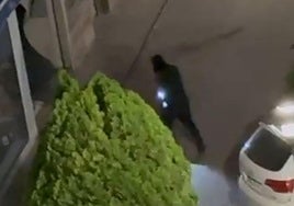 Uno de los ladrones entrando al establecimiento y el coche blanco con el que se ha realizado el alunizaje en la perfumería de Aranda.