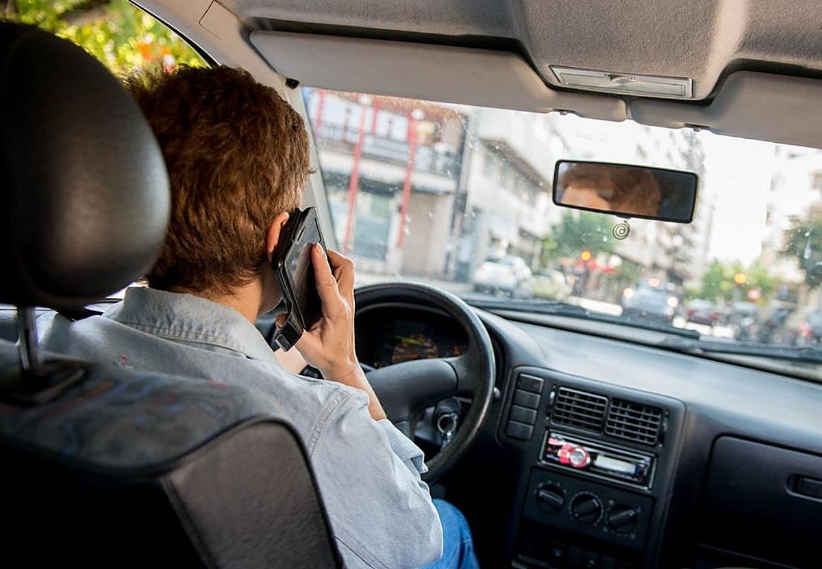 Un conductor usar el móvil al volante, en una imagen de archivo.