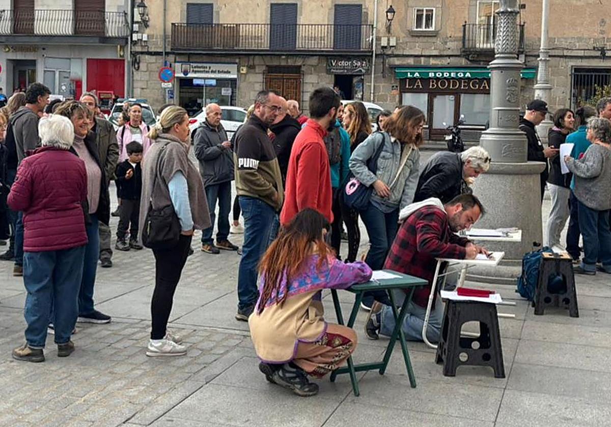 Vecinos recogen firmas durante el acto de protesta de ayer.