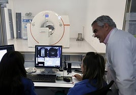 El doctor Ruano sigue junto a dos técnicos la prueba que se le realiza a un paciente en el PET-TAC del Hospital Clínico Universitario de Valladolid