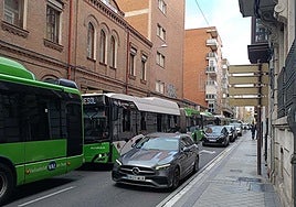 Hilera de coches y autobuses este viernes por la mañana en la calle López Gómez.