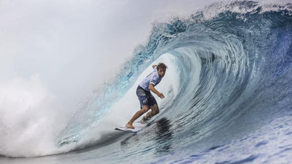 Un surfista toma una ola. 