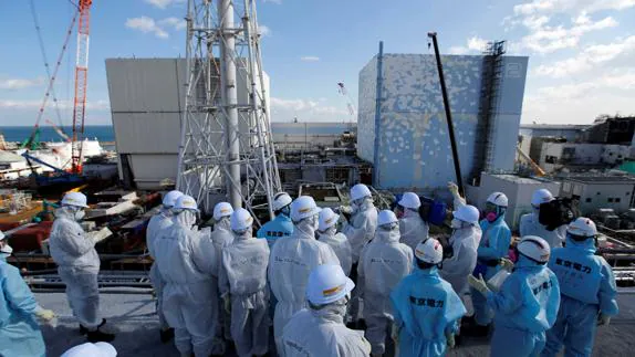 Miembros de la prensa y empleados de TEPCO, enfrente de los reactores 1 y 2 de Fukushima. 