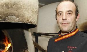 Marco García junto a uno de los hornos tradicionales del asador Mannix, de Campaspero./ Agapito Ojosnegros