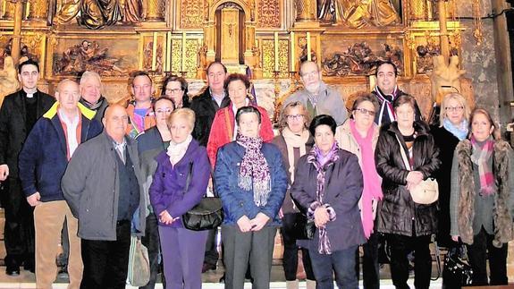 Los nazarenos posan con el padre Julio Alberto de Pablos en la basílica de la Gran Promesa, en Valladolid, durante la peregrinación.