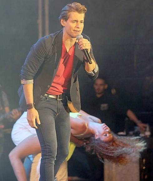 Carlos Baute, durante una de las canciones de la noche, con la bailarina en plena acrobacia. 