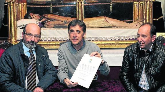 Pedro Delgado muestra el documento entre Miguel Hernández y Raúl Santos. 