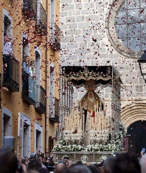Cientos de pétalos de rosa caen sobre el palio de la imagen de Nuestra Señora de la Esperanza.