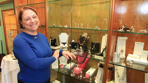Victoria Moro de Andrés, junto a algunas vitrinas del escaparate de la tienda. 