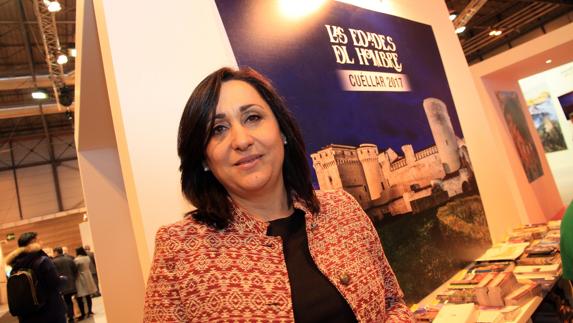 La concejala de Turismo de Cuéllar, Nuria Fernández, delante del cartel anunciador de Las Edades. Tanarro