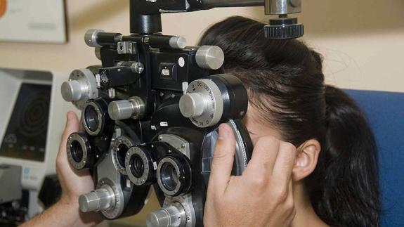 Una joven se somete a una revisión de su capacidad visual.  