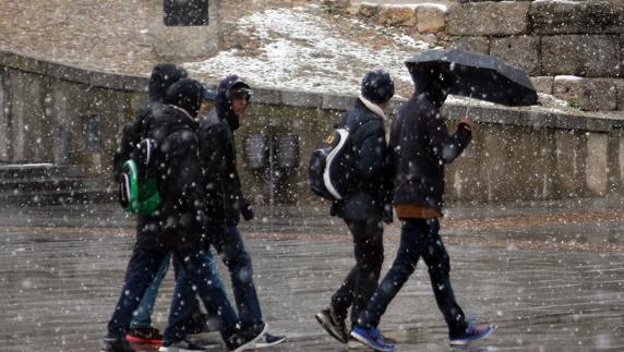 Un grupo de jóvenes caminan bajo la nieve. Antonio de Torre