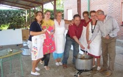 El alcalde de Villamuriel -derecha- da el visto bueno al guiso para iniciar el reparto. / EL NORTE
