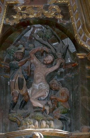 San Bartolomé se retuerce de dolor en el retablo de la iglesia.