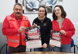 Los organizadores posan con el cartel del concierto